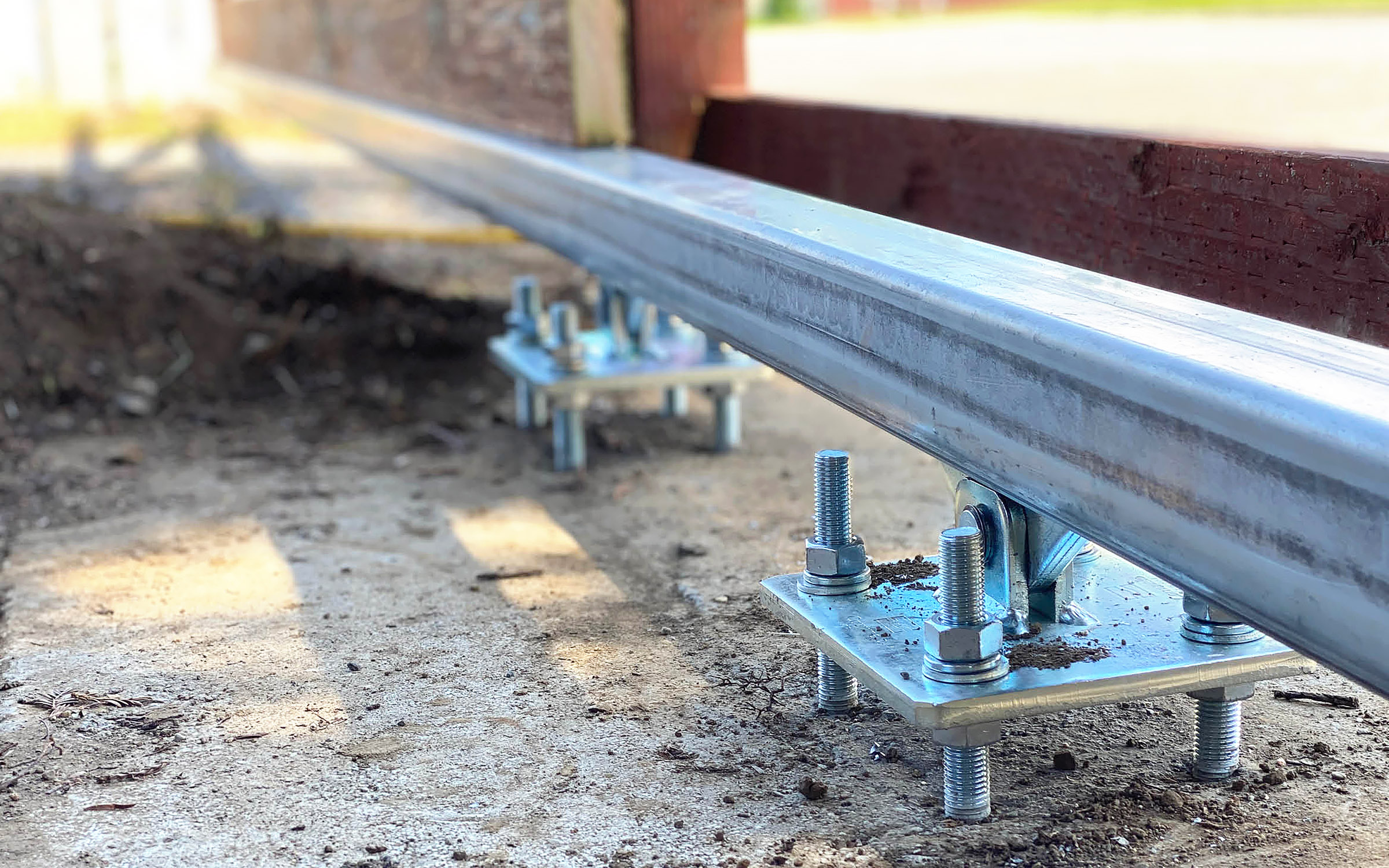 DuraGates Cantilever Sliding Gate Carriages Enclosed Within Track Installation Image